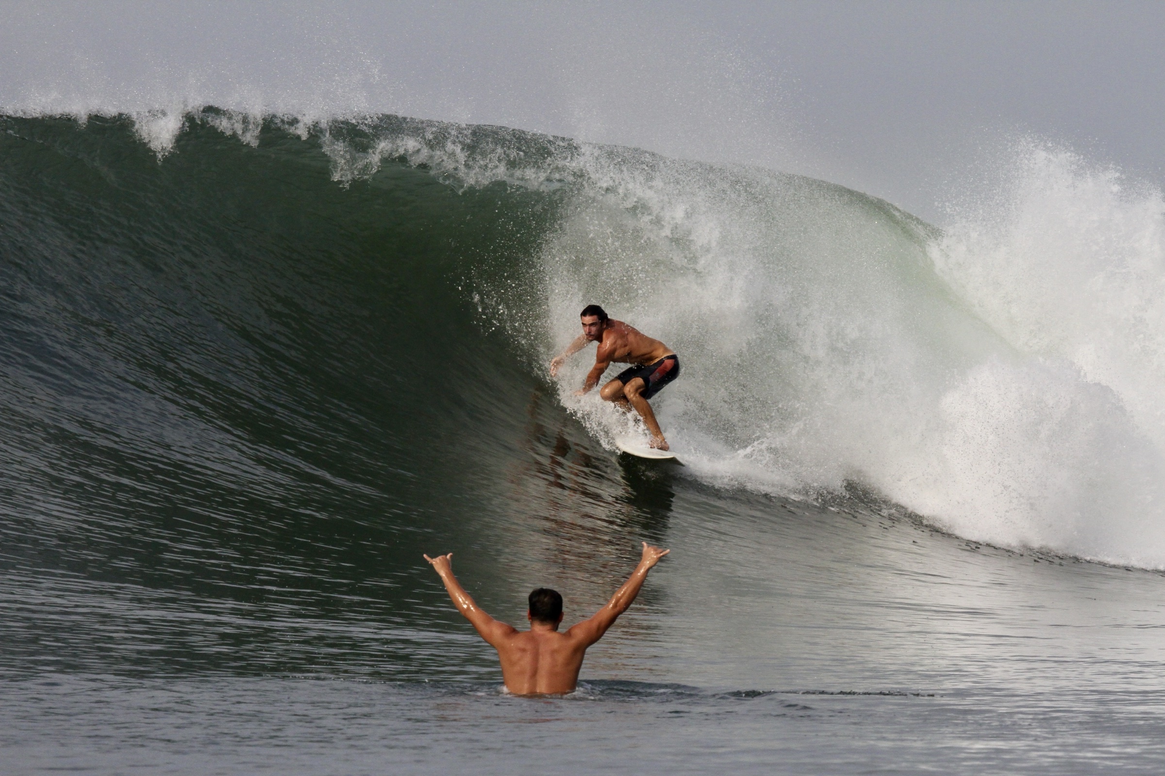 Surfer riding inside a powerful breaking wave